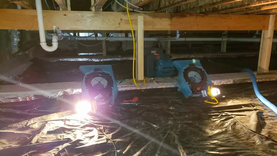Drying equipment and plastic sheeting in a crawl space